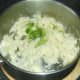 Chopped green onions are added to mashed potato