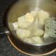 Mashing potatoes with butter and white pepper