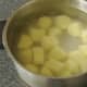 Peeled potatoes are steeped in cold water