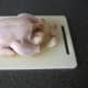 Leg ends and parson's nose are trimmed from chicken