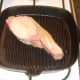 Starting to griddle back bacon steak