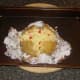 Spicy cheddar cheese added to baked potato