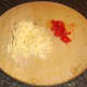 Grated cheddar cheese and diced red chilli pepper