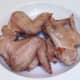 Roast chicken wings are left to rest and cool