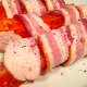 Wrap the fresh salmon fillet with bacon and secure the bacon with a toothpick.