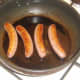 Sausages are gently fried in oil