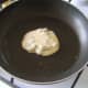 Tablespoon of pancake batter is added to hot pan
