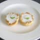 A small sprig of fresh mint garnishes each iced Christmas pudding pie