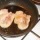 Middle bacon is fried in pan vacated by sausages