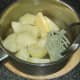 Mashing boiled potatoes