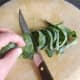 Starting to slice the rolled cabbage leaf.