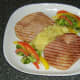 Apple and pineapple sauce is plated with gammon steaks