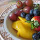 Pieces of fruit laid separately without mixing together makes an attractive fruit bowl served with any breakfast menu. Includes sliced strawberries, sliced mango, red grapes and blueberries.