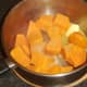 Butter and nutmeg are added to sweet potatoes