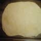 Put the flattened dough onto a pizza pan or baking sheet
