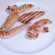 Chicken strips are removed from griddle to rest