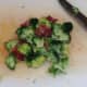 Chopped bacon and broccoli are seasoned with black pepper and combined