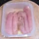 Oiled and seasoned chicken breast strips