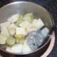 Butter and pepper added to potatoes and broccoli stalks for mashing