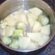 Potatoes and broccoli stalks ready for boiling