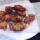 Broccoli, sweetcorn and potato fritters are drained on kitchen paper