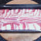 Bacon edges are folded over top of meatloaf