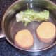 Half sweet potato and broccoli stalk are set aside in cold water