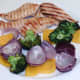 Vegetables are slid from skewers on to plate