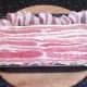 Bacon strips laid on top of meatloaf mix