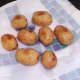 Pan roasted potatoes are drained on kitchen paper