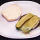 Pickles are laid on cheese stuffed mushrooms
