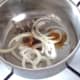 Onion and seasonings are added to pot with oil