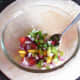 Basil and seasonings are added to the salsa ingredients