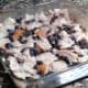 The bread squares are mashed with a fork so that they will soak up the milk-egg mixture.
