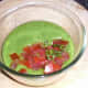 Tomato and basil added to blended zucchini guacamole