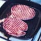 Gammon steaks are turned in griddle pan