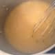 Once all of the cornmeal is whisked in, continue to stir the polenta for a few minutes, it will start to thicken.