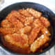 Soy tempeh simmering in tomato and chili sauce.