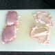 Skin is pulled from chicken thighs