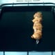 Pork meat skewer is turned regularly on grill tray