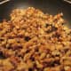 When walnuts are golden and the sugar is melted, take it off the heat. Keep in pan so the nuts can stick together like a brittle should.