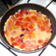 Beaten eggs are poured in to pan