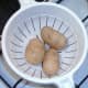 Boiled potatoes are drained and cooled