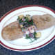 Bruschetta is plated alongside samphire salad