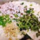 The batter with the chopped ginger, chopped dry coconut, curry leaves, and green chili