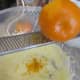 Grating the orange rind with a microplane.
