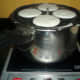 Idli stand inside the cooker, ready for steaming. Just to place the lid.