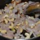 Step three: Stir-cook onion, ginger, garlic, and cashew nuts.