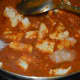 Step five: Pour some water and boil the gravy. Add sugar and salt. Also add paneer cubes. Simmering continues.