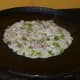 Prepare your chopped onion and other ingredients. Make a pancake using the batter. Top it with the onion mix. Gently press the top.